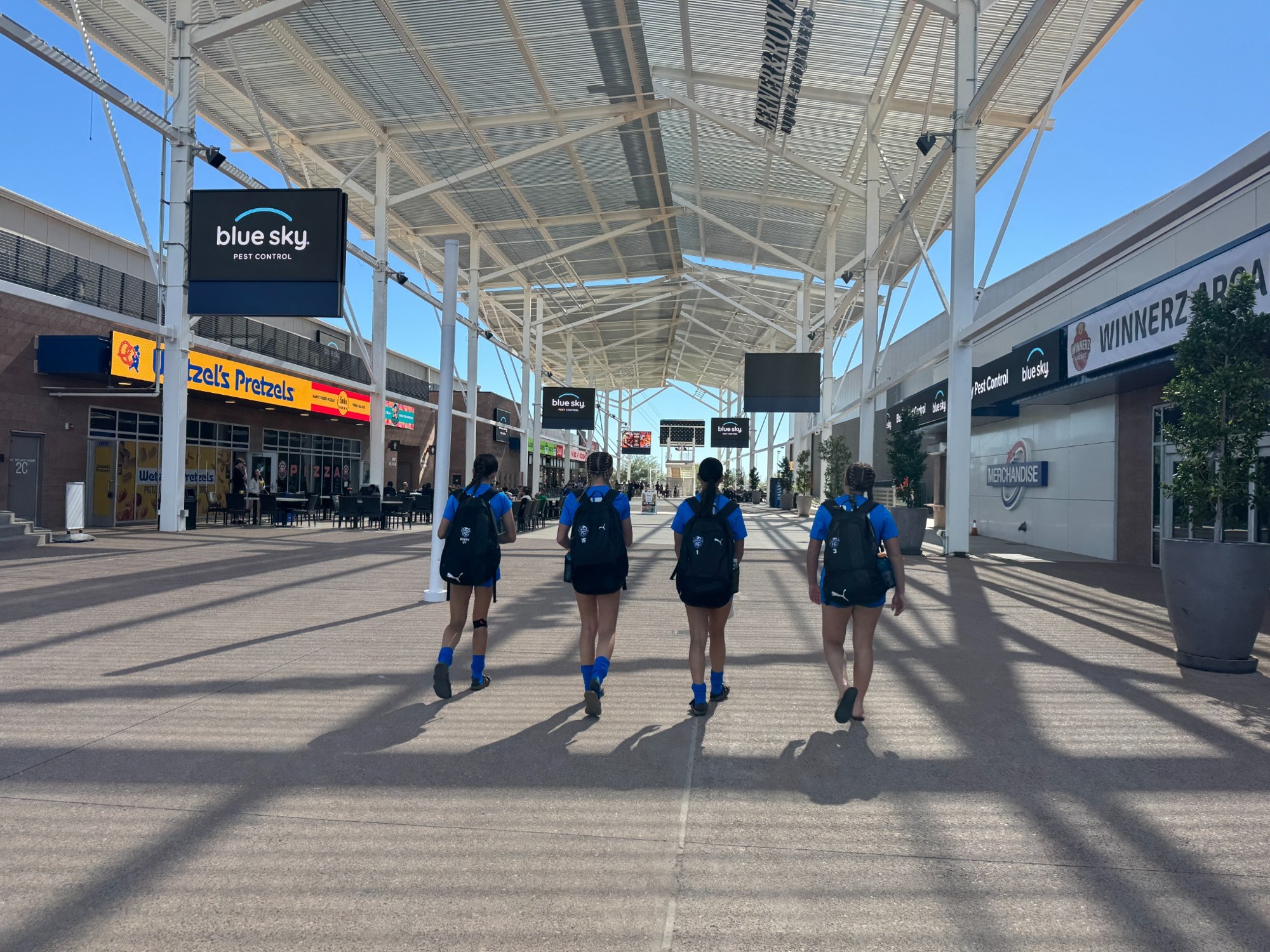 Teammates walking through an outdoor shopping center